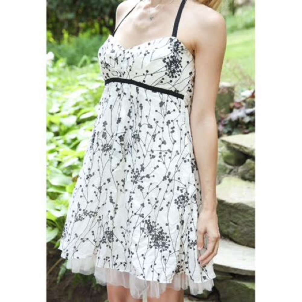 X X i white dress with black floral pattern.